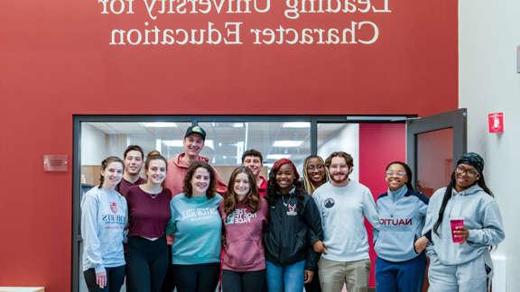 students at roberts in front of character education sign